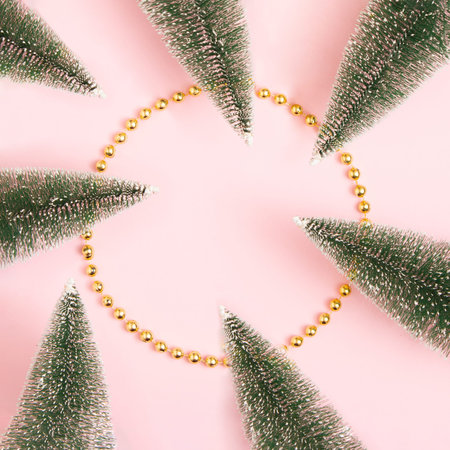 On a pink pastel background, a glass with a red ornament in it. Minimal creative idea. New Year 2022の写真素材