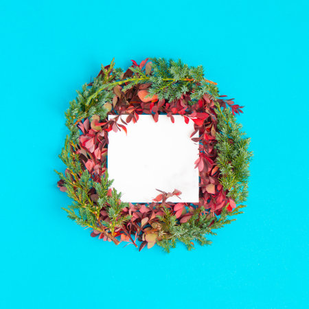 On a pink pastel background, a glass with a red ornament in it. Minimal creative idea. New Year 2022の写真素材