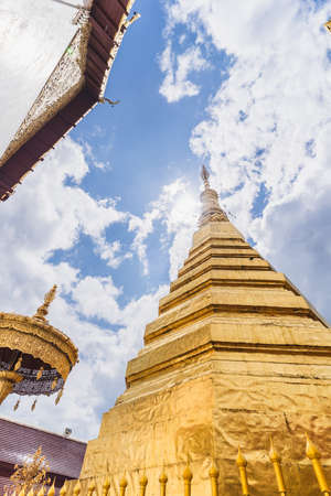 Golden pagoda of Wat Prathat Cho Hae, Phrae, Thailand.の写真素材