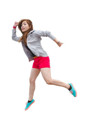 Asian women wear shorts, black shirts, gray robes and bright sneakers are jumping happily.の写真素材
