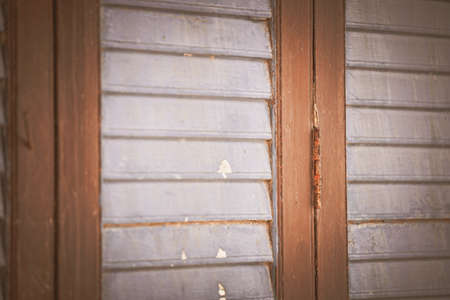 The hinges of the windows in the ancient wooden house that are rusty and run down.の写真素材