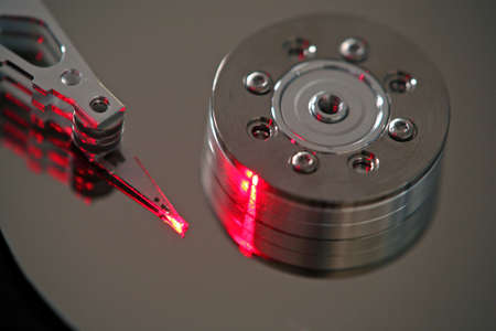 computer harddrive close up with red laser lightの写真素材