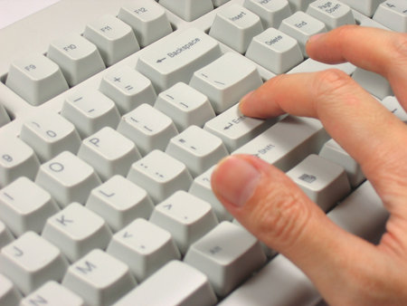 Finger pressing the Enter key