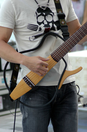 Street musician playing an electric guitar