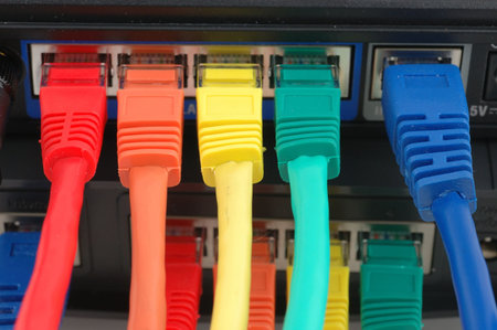 Close up of multi color cables connected to a router