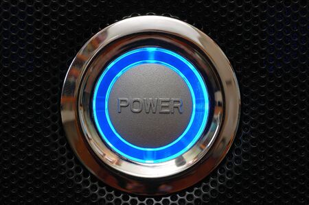 Computer power button with blue lightの写真素材