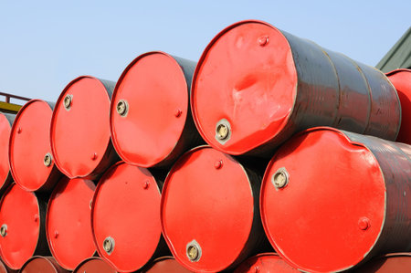 Stack of industrial red drums over skyの写真素材