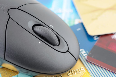 Closeup of wireless mouse over credit cards backgroundの写真素材