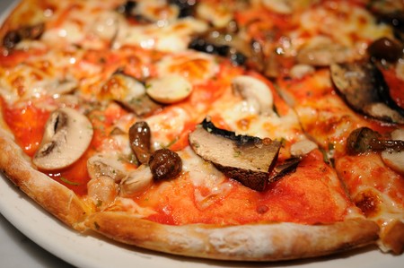 Close up of pizza topping with assorted mushroomsの写真素材