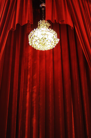 Crystal chandelier with theater stage red curtainsの写真素材
