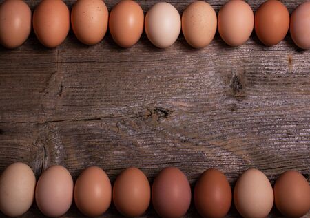 fresh colorful eggs in a wooden backgroundの写真素材