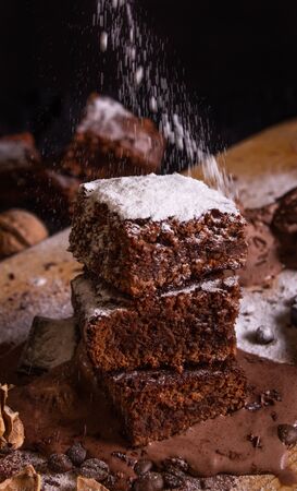 homemade chocolate brownie with icecream surrounded by decorationsの写真素材