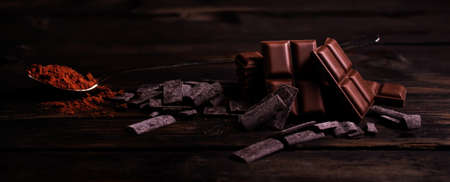 dark brown chocolate in a wooden backgroundの写真素材