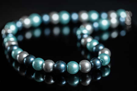 blue pearl necklace in a black backgroundの写真素材