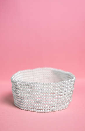 beautiful white necklace on a pink backgroundの写真素材