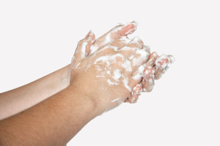 Woman hands isolated on white background. Washing hands with soap bubbles.