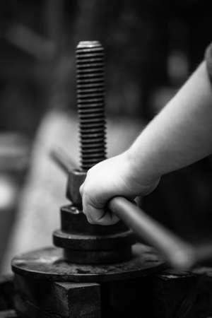 Farmers hands holding the machine. Farmer making red vine from purple grpapes.の写真素材