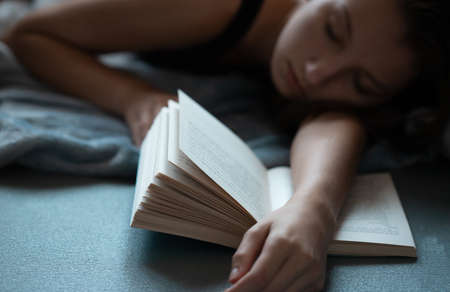 Girl fell asleep while she was studying.の写真素材