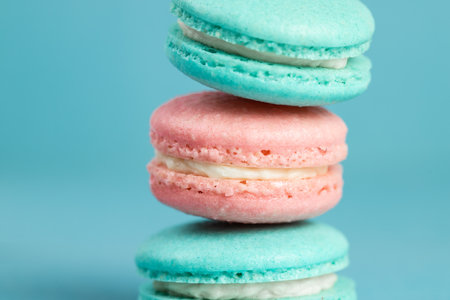 Colorful sweet macarons on a blue background. French dessert.の写真素材