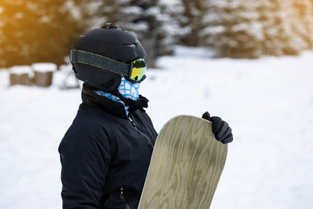 Young girl snowboarder holding her snowboardの写真素材