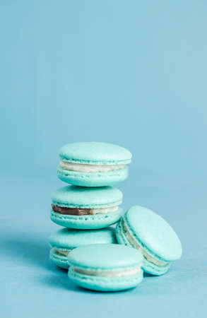 Blue handmade macarons on a blue backgroundの写真素材