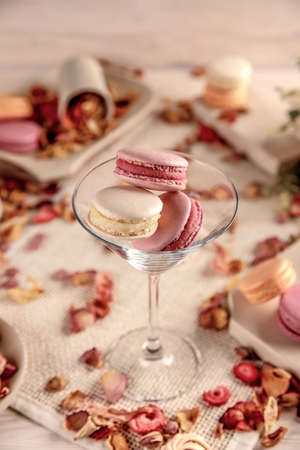 Colorful macarons in a glass, on a white backgroundの写真素材
