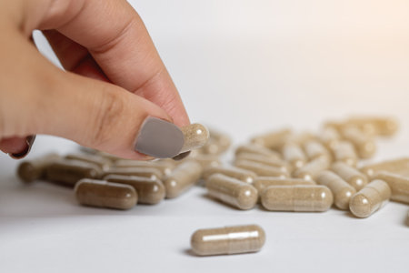Vitamine E capsules on a white background. Alternative herbal medicine.の写真素材
