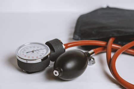 Medical equipment including stethoscope and blood pressure meter on white background.の写真素材
