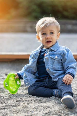 Little blond haired boy playing on the playground. Happy boy.の写真素材