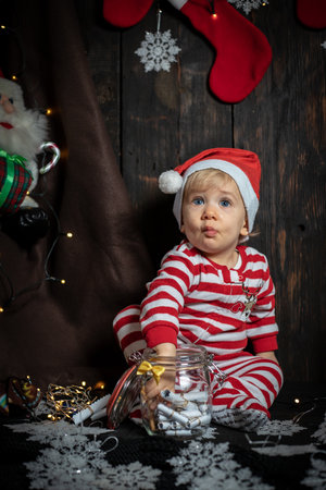 Cute baby boy searching for Christmas cookies. Baby's first Christmas.の写真素材