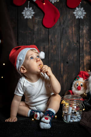 Cute baby boy searching for Christmas cookies. Baby's first Christmas.の写真素材