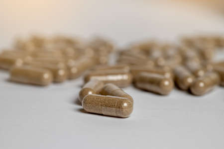 Vitamine E capsules on a white background. Alternative herbal medicine.の写真素材