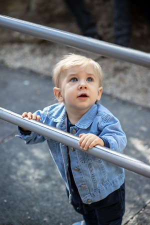 Little blond haired boy playing on the playground. Happy boy.の写真素材