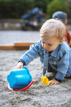 Little blond haired boy playing on the playground. Happy boy.の写真素材