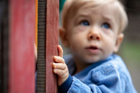 Little blond haired boy playing on the playground. Happy boy.の写真素材