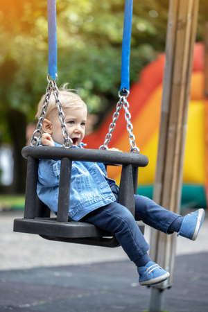 Little blond haired boy playing on the playground. Happy boy.の写真素材