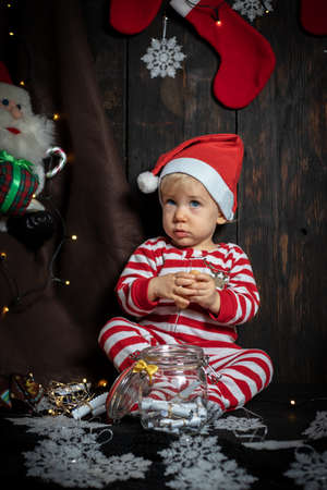 Cute baby boy searching for Christmas cookies. Baby's first Christmas.の写真素材