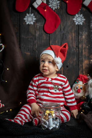 Cute baby boy searching for Christmas cookies. Baby's first Christmas.の写真素材