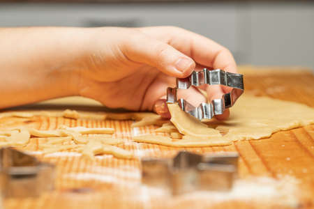 Unrecognizable woman making gingerbread in the kitchen. Christmas season.の写真素材