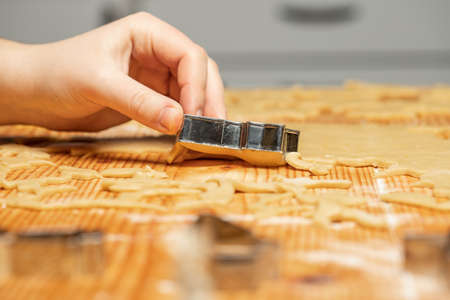 Unrecognizable woman making gingerbread in the kitchen. Christmas season.の写真素材