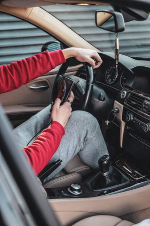 Young boy using his phone in the freshly cleaned car.