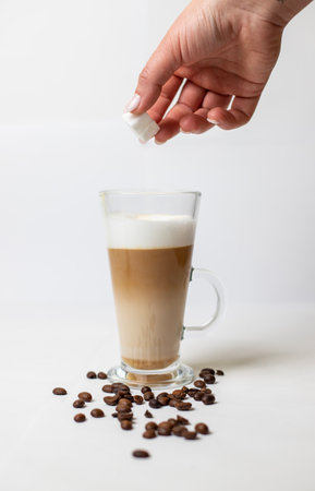 latte macchiato on a white background surrounded with coffee beans. Latte macchiato on white bacgkround.の写真素材