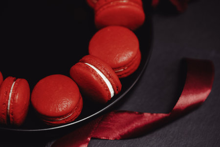 Red macarons for Valentine's day on a bright background.の写真素材
