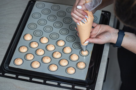 A confectioner making macarons. Macarons in the making.の写真素材