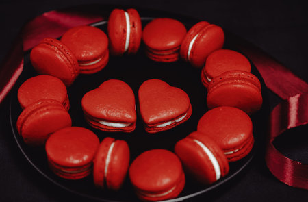 Red macarons for Valentine's day on a bright bacgkround.の写真素材