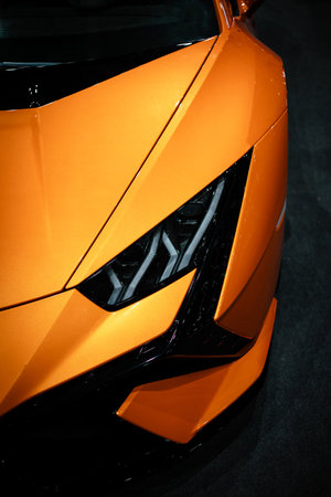 Close up of a headlight. Headight of a orange car. Luxury car.の写真素材