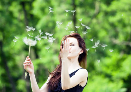    Girl and dandelion の写真素材