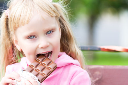 Happy little girl with a chocolates