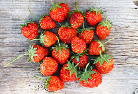 Ripe strawberry on wood の写真素材