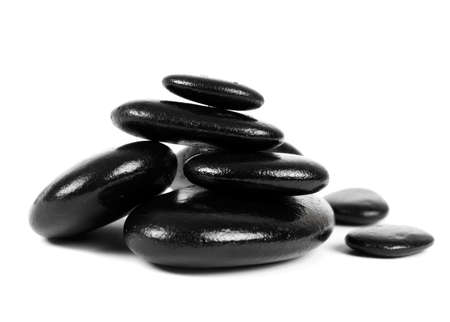Black stones over white backgroundの写真素材